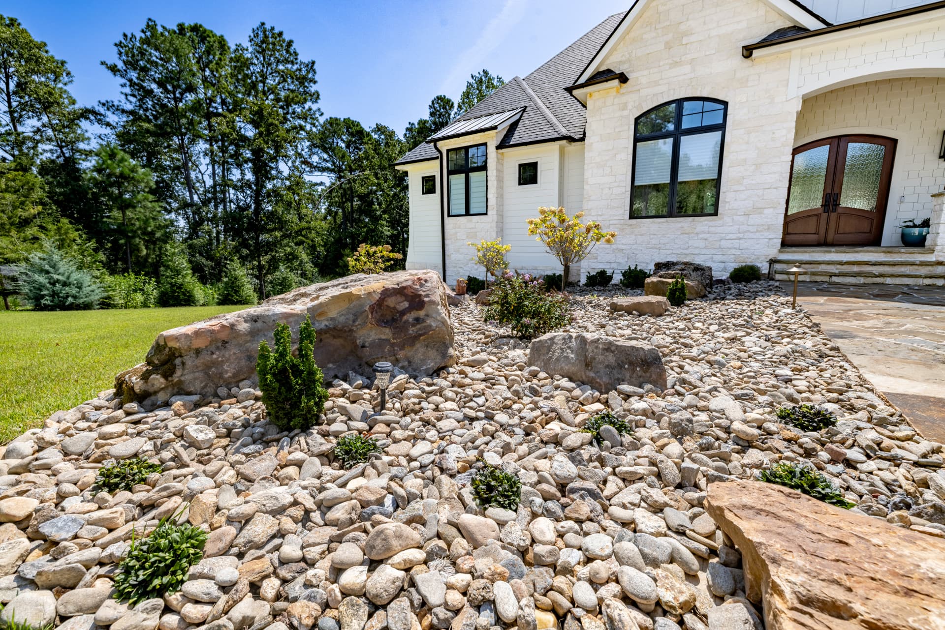 A freshly maintained residential property with clean bed edges